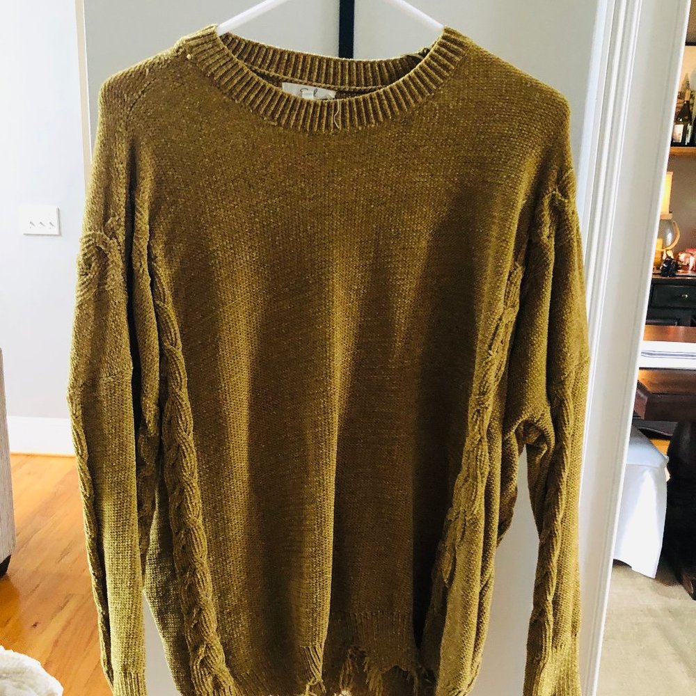 green sweater with fringe
